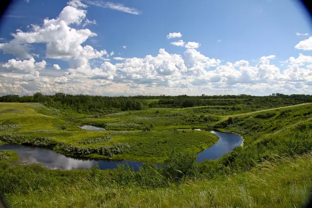 Creek winding through the valley under a big sky